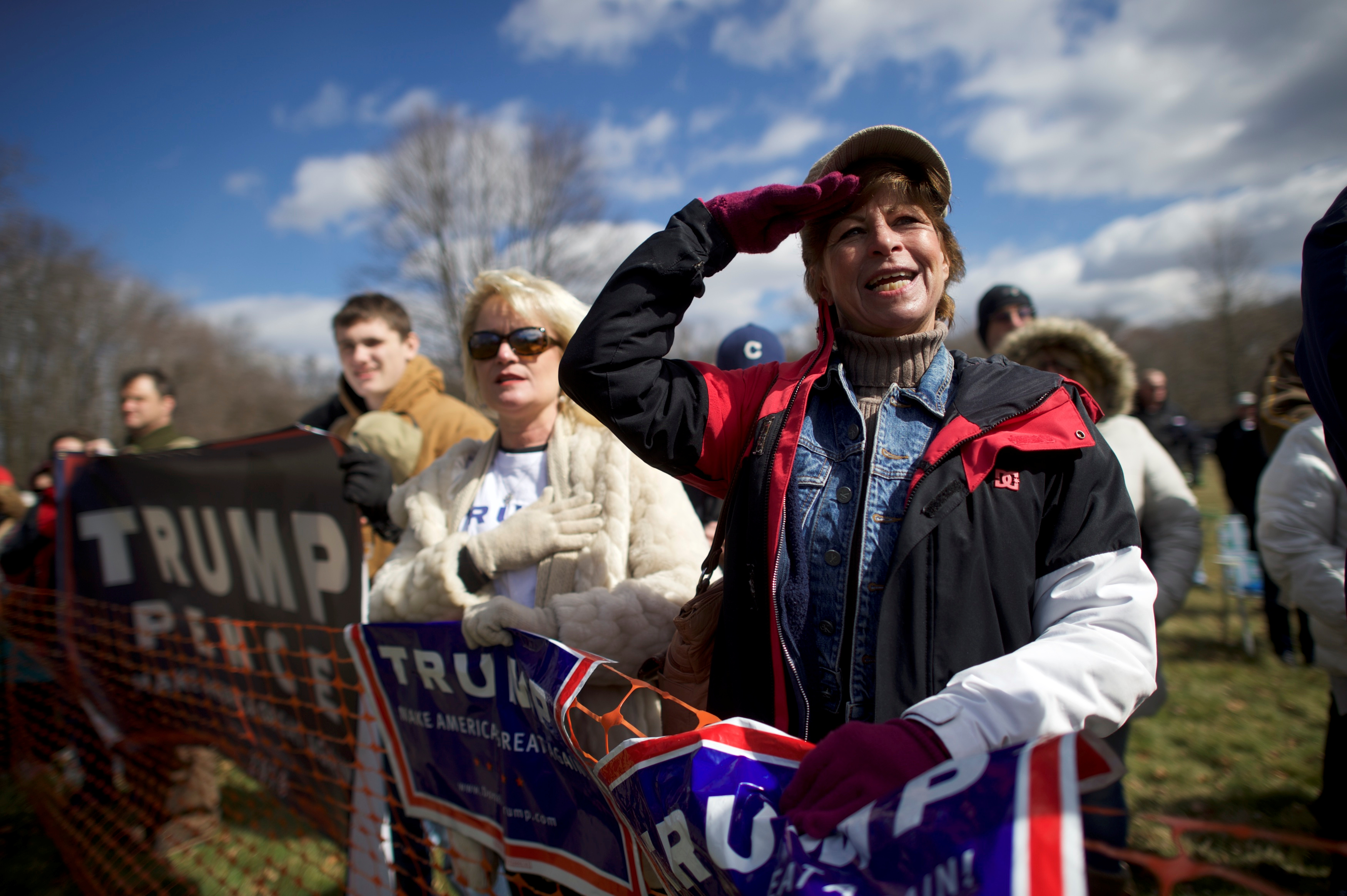 Donald Trump supporter Beth Holz salutes during a "People 4 Trump" rally at Neshaminy State Park in Bensalem