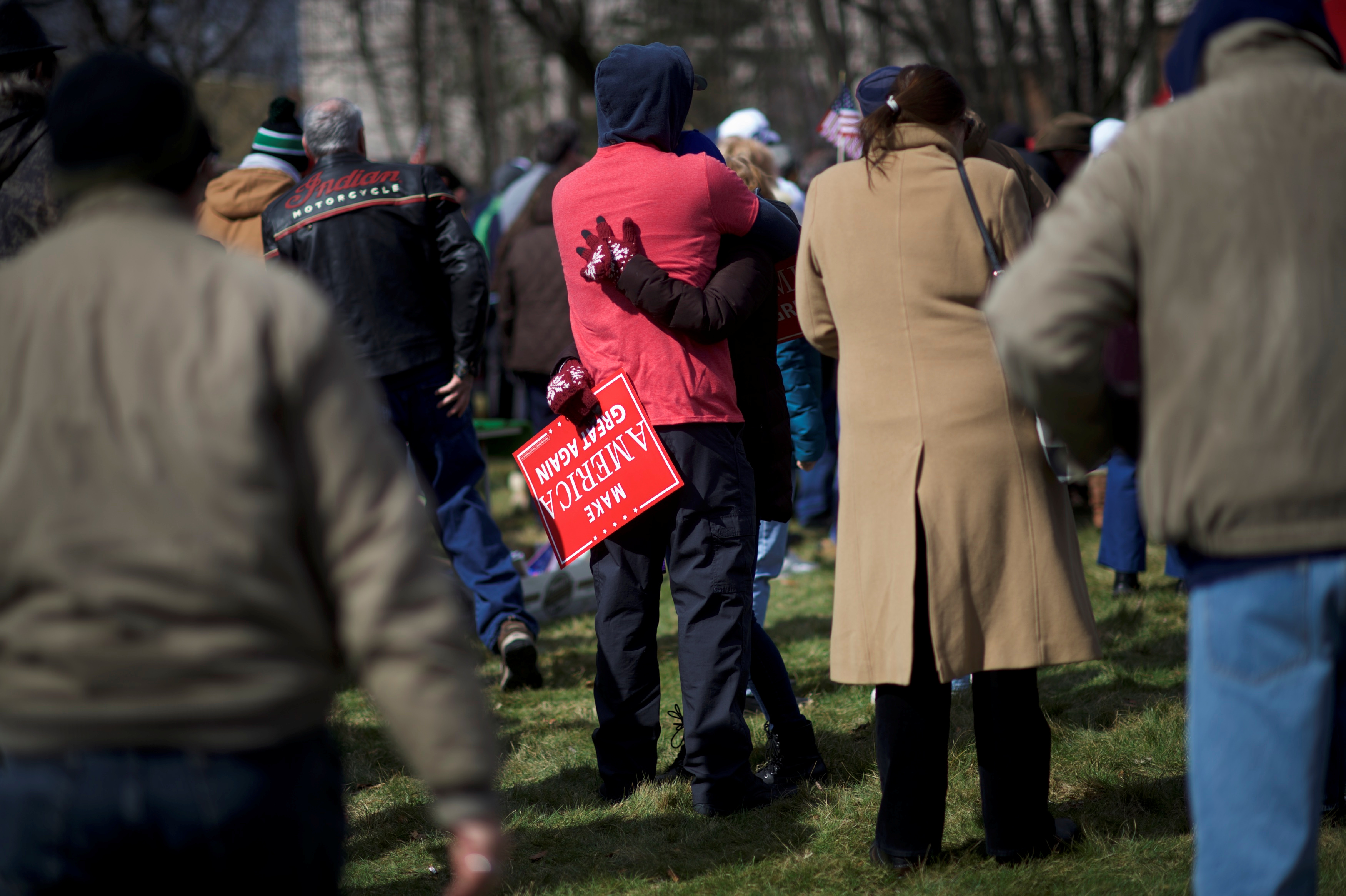 Eric Falco, 32, embraces Alyssa Klingman, 23, while holding a "Make America Great Again" sign during a "People 4 Trump" rally at Neshaminy State Park in Bensalem