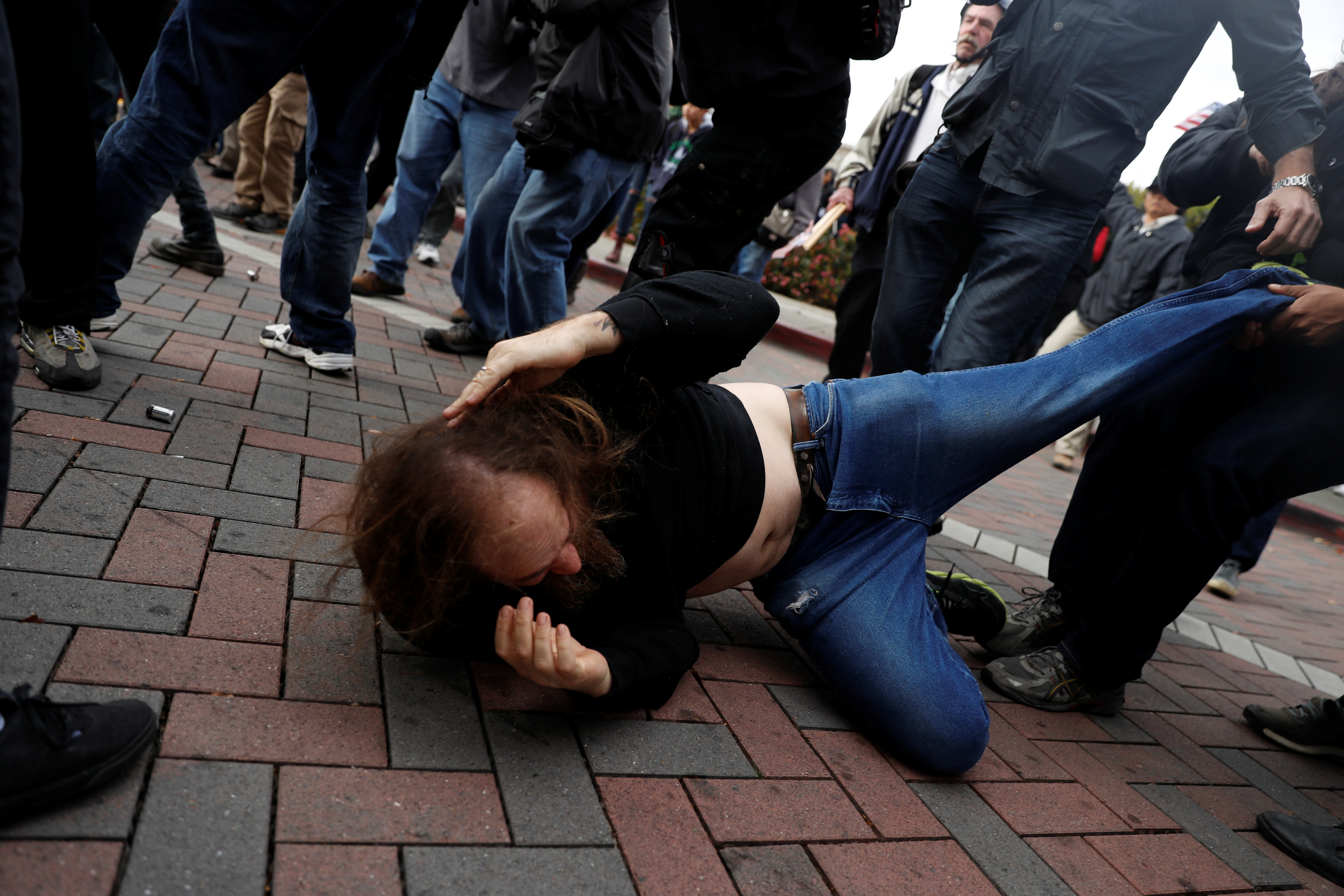A man is being pulled away from a scuffle as scattered fights broke out between supporters of U.S. President Donald Trump and counter-protestors during a "People 4 Trump" rally in Berkeley, California